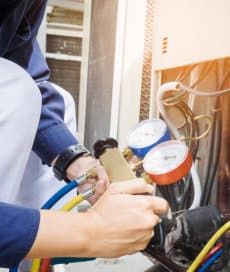 handyman checking refrigerator pressure